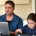 Man working from home surrounded by her two children and wife 8 ways to work from home effectively during lockdown blog