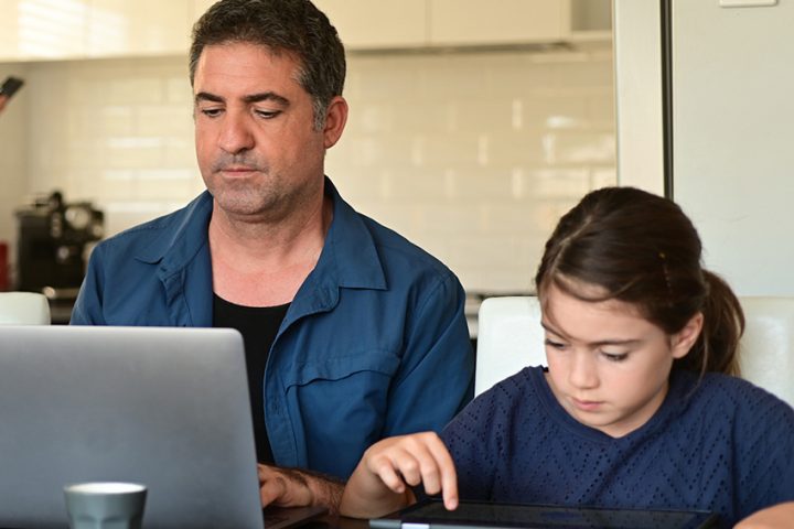 Man working from home surrounded by her two children and wife 8 ways to work from home effectively during lockdown blog