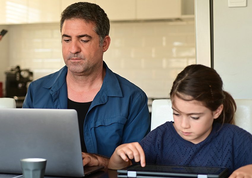 Man working from home surrounded by her two children and wife 8 ways to work from home effectively during lockdown blog